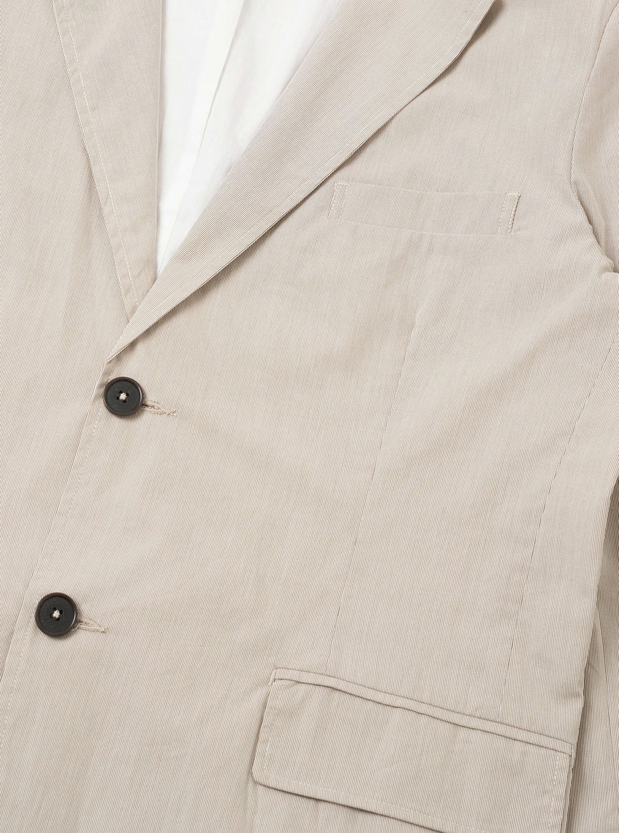 The Brown Kennedy Stripe Boston Blazer is shown from the back as a flat lay against a plain white background. The image highlights the clean lines of the rear panel, the vertical brown and cream stripes, and the simple construction of the shoulders and hem.