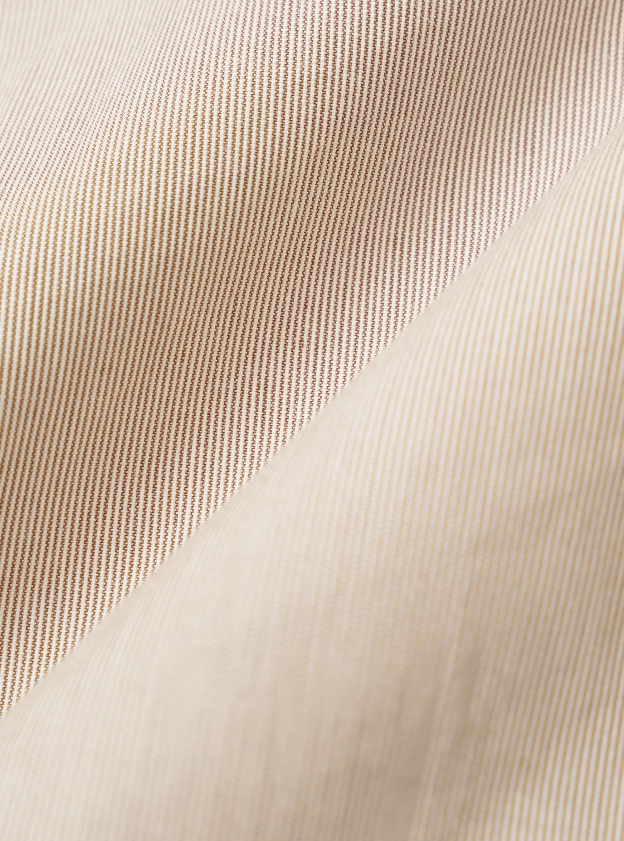 A close-up fabric swatch of the Brown Kennedy Stripe Boston Blazer displays a textured cotton material with a pattern of vertical brown and off-white stripes. The fabric fills the entire frame, highlighting the fine weave and the consistent spacing of the striped design.