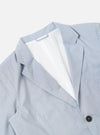 The Navy Kennedy Stripe Boston Blazer is shown from the back as a flat lay against a plain white background. The image highlights the horizontal navy and white stripes of the cotton fabric, a central vertical seam, and the clean lines of the shoulders and hem.