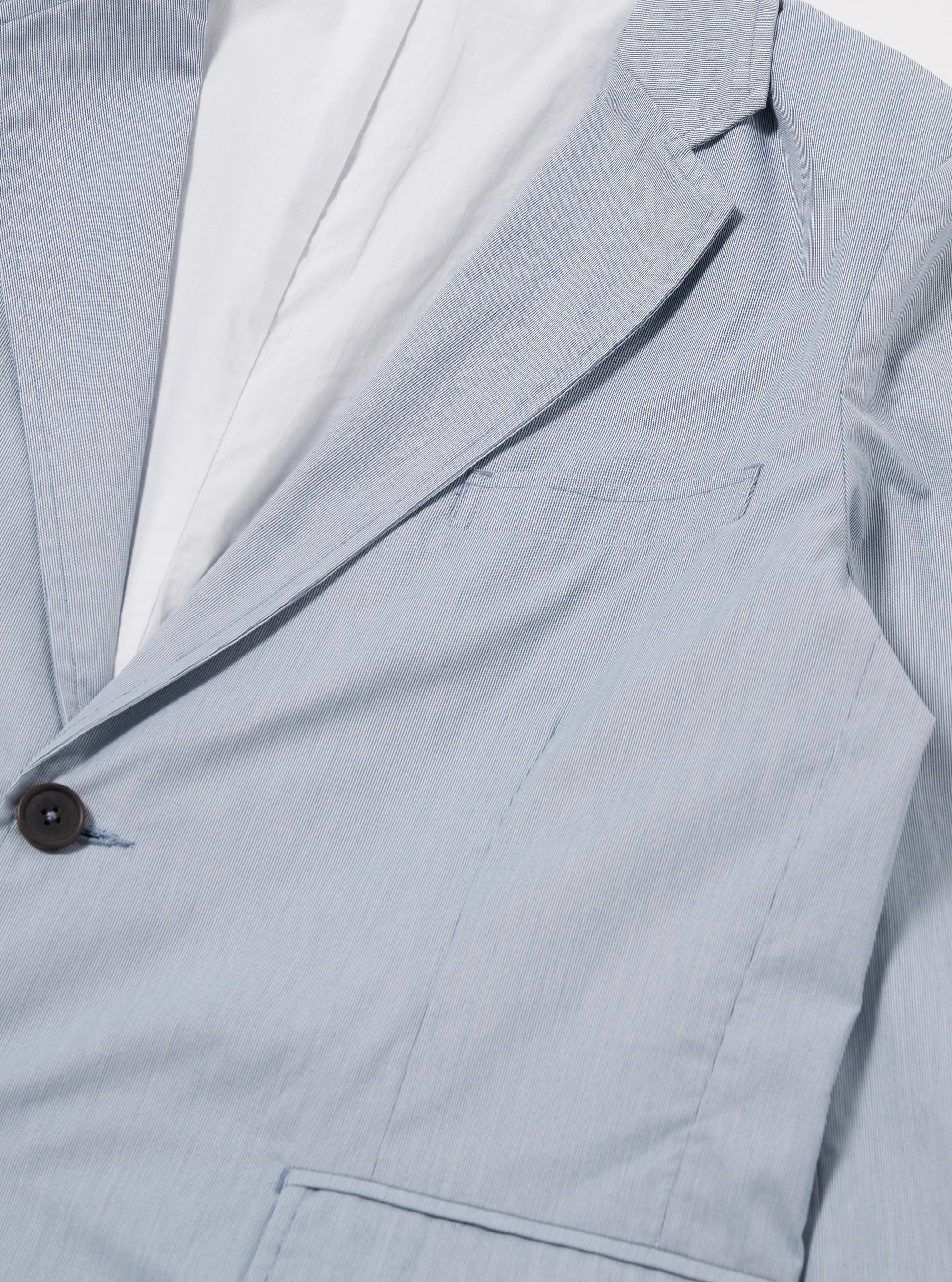 The Navy Kennedy Stripe Boston Blazer is shown as a flat lay against a white background. The blazer features a vertical navy and white stripe pattern, a notched lapel, a three-button front closure, and three patch pockets on the front.