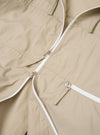 The Sand Cotton Recycled Nylon Mix Daley Jacket is shown from a rear angle as a flat lay against a plain white background. The jacket features a large hood, a straight hem, and a clean back panel construction. The sand-colored fabric has a smooth, matte finish.