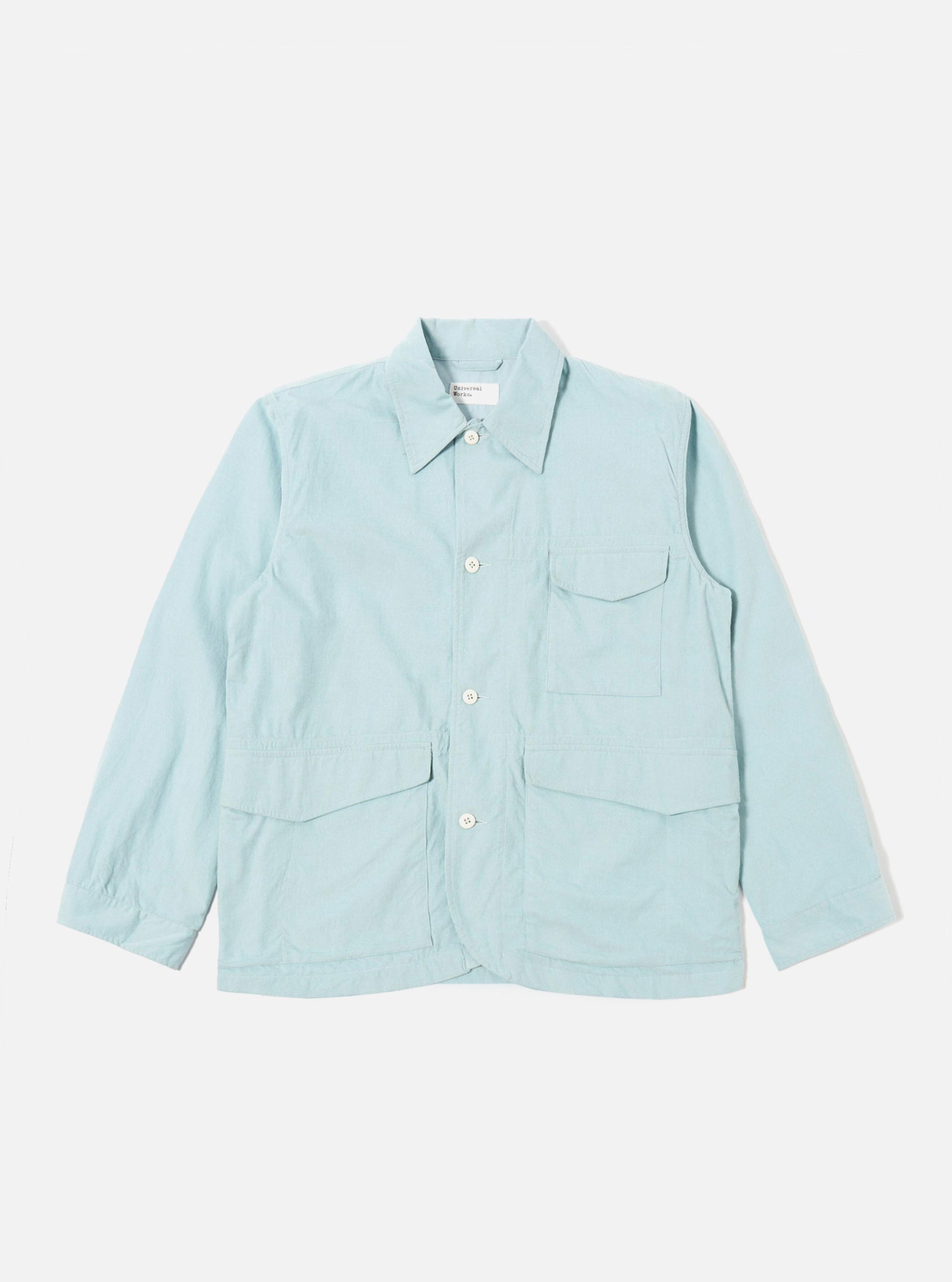 The Aqua Organic Fine Cord Duty Jacket is shown as a flat lay against a plain white background. The jacket features a four-button front closure, three large patch pockets, and a smaller ticket pocket on the chest. The fine corduroy fabric is a light aqua blue color.