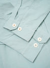 The Aqua Organic Fine Cord Duty Jacket is presented as a flat lay against a plain white background. The jacket features a structured collar, a button-front closure, and three large patch pockets on the front. The fine-ribbed texture of the aqua-colored organic cotton corduroy is clearly visible.