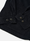 The Black Organic Fine Cord Duty Jacket is shown in a detail view as a flat lay against a white background. This shot focuses on the upper section of the jacket, highlighting the classic spread collar, the top button of the front placket, and the fine texture of the black corduroy fabric.