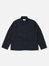 The Dark Navy Ospina Cotton Duty Jacket is presented as a flat lay against a plain white background. The jacket features a five-button front closure, a structured collar, and three prominent patch pockets on the front. The fabric displays a subtle, puckered seersucker texture.