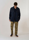 The Indigo Kaihara LT WT Denim Jungle Jacket is shown as a flat lay against a plain white background. This lightweight indigo-dyed denim jacket features a camp collar, a concealed button front placket, and four prominent front patch pockets with buttoned flaps. The design includes two angled chest pockets and two larger bellowed waist pockets.