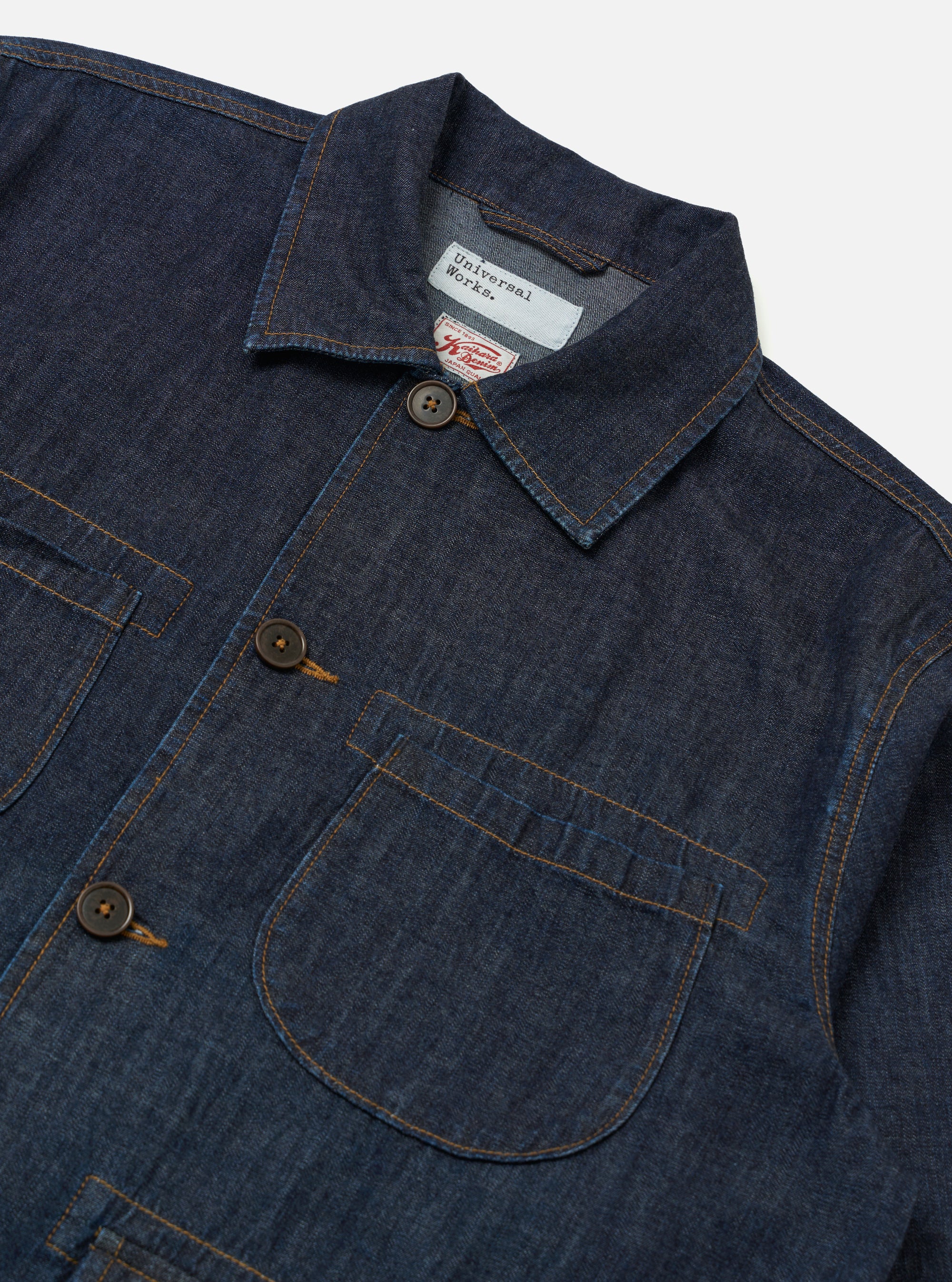 The Indigo Kaihara LT WT Denim Labour Jacket is shown as a flat lay against a white background. The jacket features a collared neckline, four front pockets with reinforcement stitching, and a button-front closure. The lightweight indigo-dyed denim fabric shows visible texture and a deep blue color.