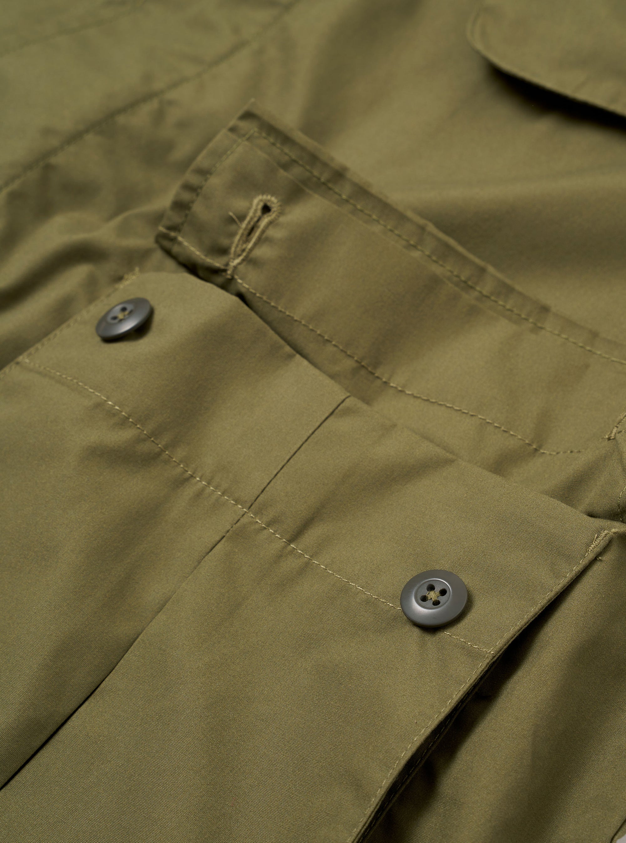 The Olive Recycled Polytech Jungle Jacket is shown from the back as a flat lay against a plain white background. The image highlights the horizontal back yoke and the clean construction of the shoulders and sleeves.