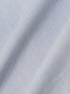 A close-up fabric swatch of the Navy Kennedy Stripe Labour Jacket displays the detailed pattern of the organic cotton material. The fabric features vertical white stripes of varying thicknesses set against a dark navy blue background.