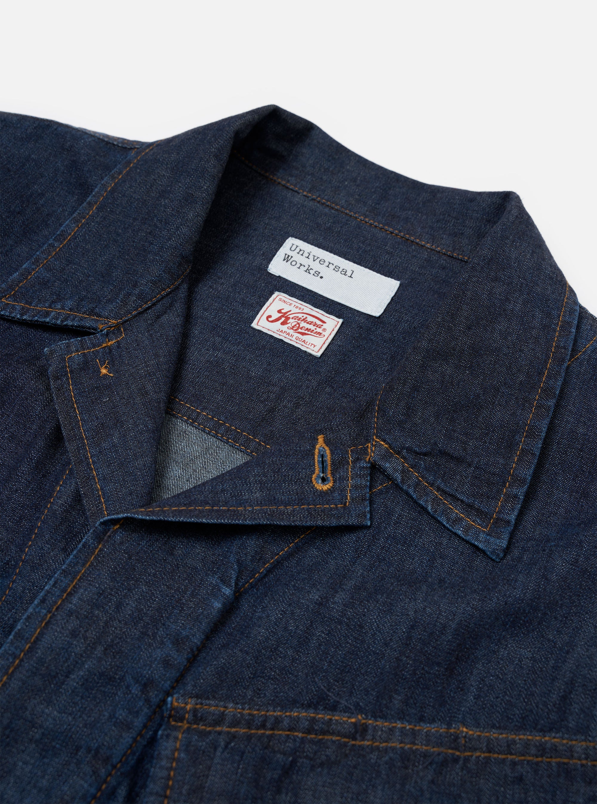 The Indigo Kaihara LT WT Denim Jungle Jacket is shown from a rear three-quarter angle as a flat lay against a plain white background. The image highlights the jacket's loose, unstructured fit, the back yoke, and the articulated two-piece sleeve construction. The indigo-dyed cotton denim fabric has a smooth, lightweight appearance with visible stitching.