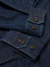 The Indigo Kaihara LT WT Denim Jungle Jacket is shown from the back as a flat lay against a plain white background. The image highlights the jacket's loose, unstructured fit, a back yoke, and articulated two-piece sleeves. The deep indigo denim fabric has a smooth texture with visible stitching along the seams.