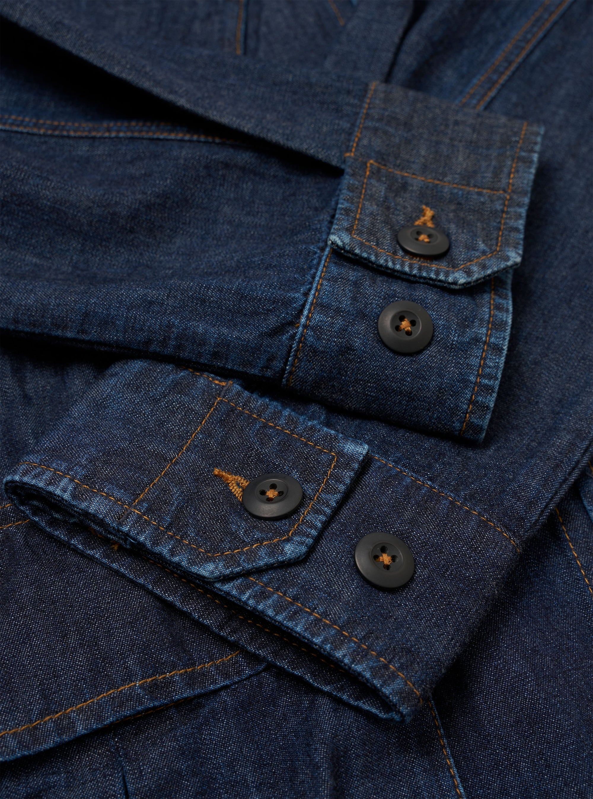 The Indigo Kaihara LT WT Denim Jungle Jacket is shown from the back as a flat lay against a plain white background. The image highlights the jacket's loose, unstructured fit, a back yoke, and articulated two-piece sleeves. The deep indigo denim fabric has a smooth texture with visible stitching along the seams.