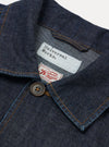 The Indigo Kaihara LT WT Denim Labour Jacket is shown in a detail view as a flat lay against a white background. The image focuses on the interior white brand label stitched onto the indigo denim fabric.