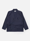 The Navy Peached Poplin Osaka Work Jacket is shown as a flat lay against a plain white background. The jacket features a wrap-front kimono-style design with a V-neckline and tie closures. It includes two large patch pockets at the waist and a single chest pocket. The navy blue cotton fabric has a smooth, matte finish.