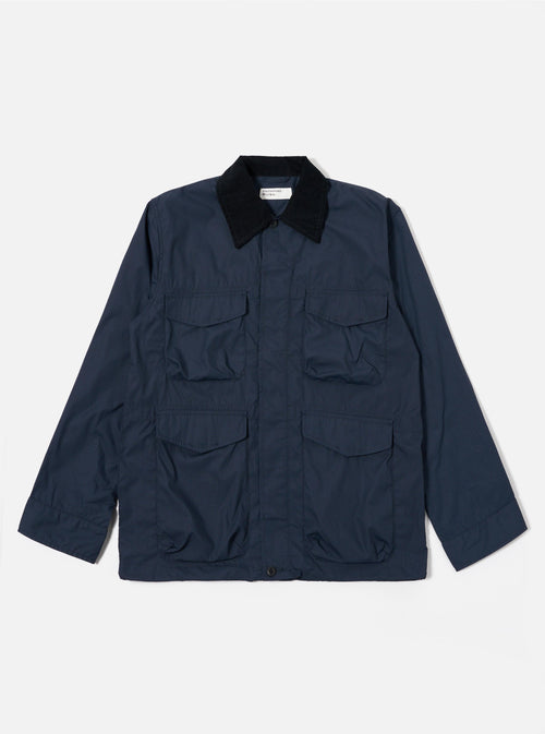 The Navy Recycled Polytech Parachute Field Jacket is shown as a flat lay against a white background. The jacket features a contrasting corduroy collar, a central button-down front, and four large 3D patch pockets with button flaps on the front. The fabric is a smooth, dark navy recycled polytech blend.