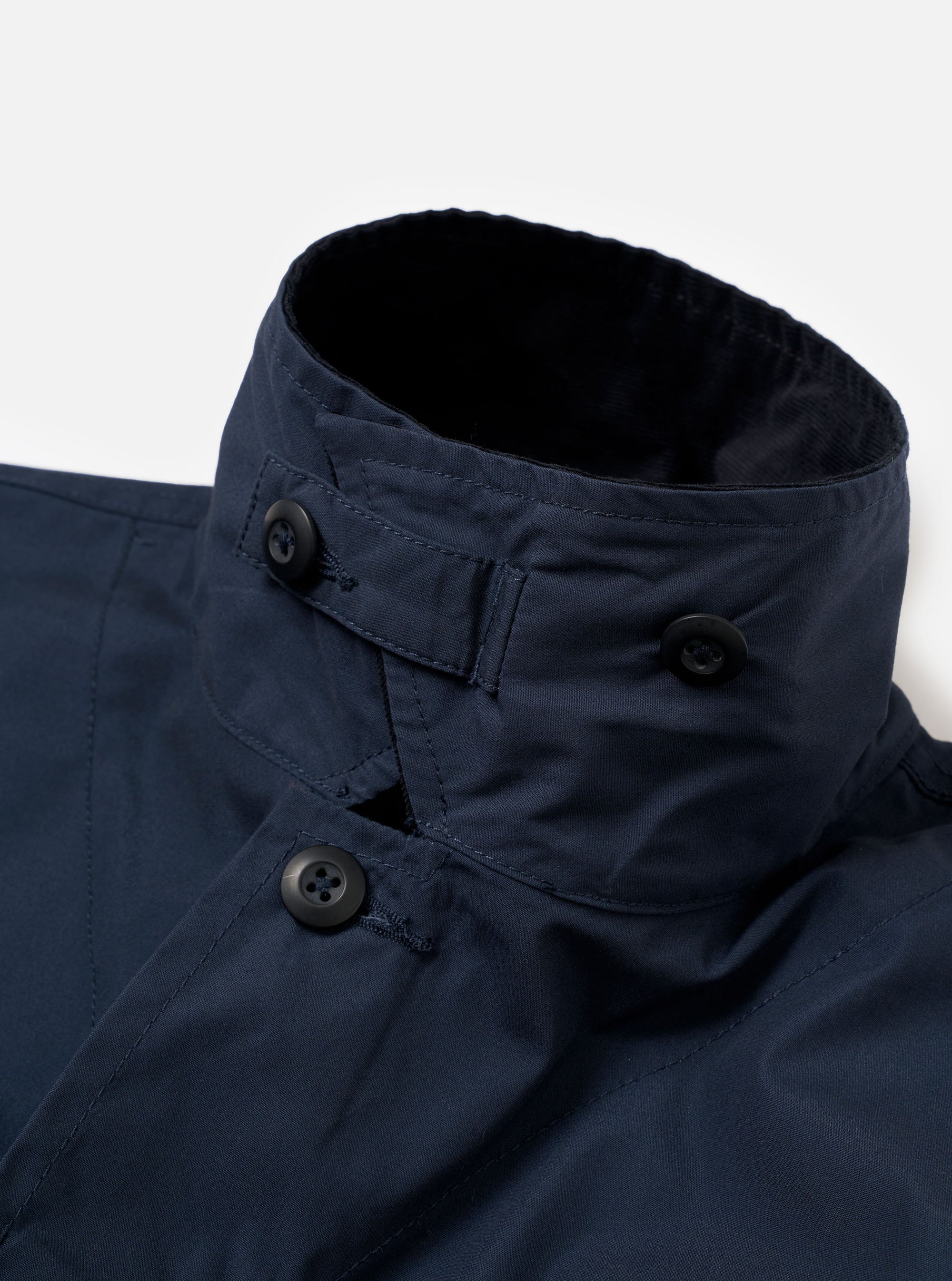 The Navy Recycled Polytech Parachute Field Jacket is shown from the back in a detail shot against a plain white background. The image highlights the adjustable drawcord hem with a toggle and the smooth, technical texture of the navy recycled polytech fabric.