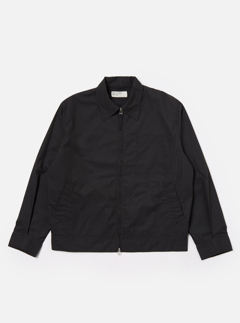 The Black Recycled Polytech Rose Bowl Jacket is shown as a flat lay against a white background. The jacket features a boxy silhouette, a zip-front closure, and an oversized collar. It has one large patch pocket on the chest and two welt pockets at the waist. The fabric is a smooth, black recycled polytech material.