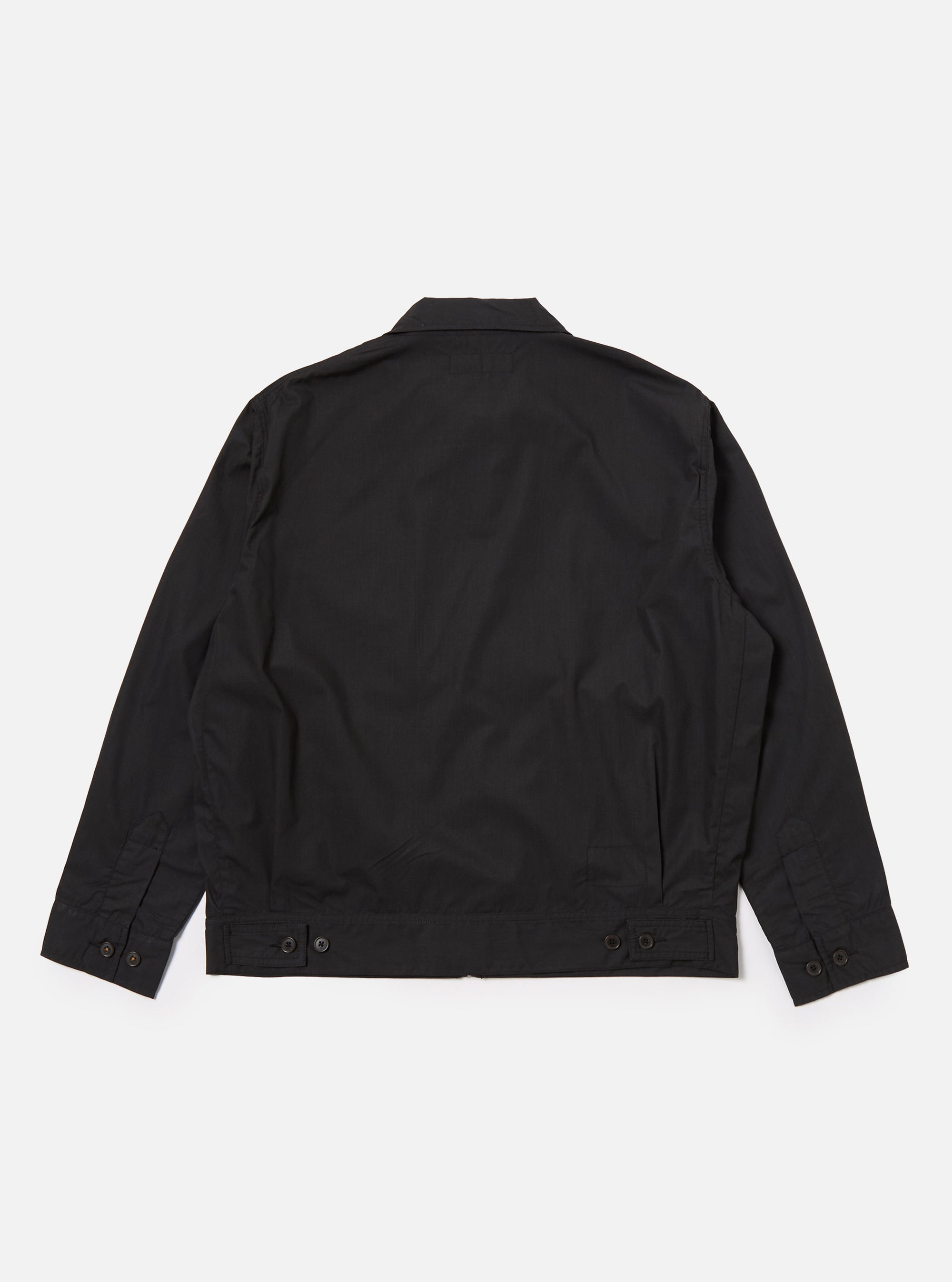The Black Recycled Polytech Rose Bowl Jacket is shown from the back as a flat lay against a plain white background. The image highlights the garment's boxy fit, oversized collar, and distinctive pleats at the back and cuffs. The adjustable back hem with button detailing is also visible on the smooth, dark fabric.