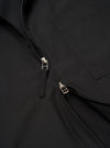 The Black Recycled Polytech Rose Bowl Jacket is shown in a close-up detail shot as a flat lay against a plain white background. The image highlights the technical texture of the black fabric and the construction of the front pockets and the central two-way zipper closure.
