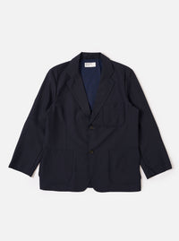 The Navy Tropical Suiting Two Button Jacket is shown as a flat lay against a white background. The jacket features a two-button front closure, a notched lapel with pick-stitching, and three front pockets, including two large patch pockets at the waist and one at the chest. The fabric is a smooth, lightweight navy tropical suiting material.