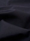 The Navy Tropical Suiting Two Button Jacket is displayed as a flat lay against a plain white background. The jacket features a two-button front closure, a notched lapel, two large patch pockets at the waist, and a single patch pocket at the chest. The navy wool-blend fabric has a smooth, lightweight appearance.