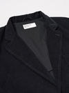 The Black Organic Fine Cord Two Button Jacket is shown from the back as a flat lay against a plain white background. The jacket features a contemporary, relaxed fit with a fine corduroy texture throughout. The rear view highlights the clean construction and the two-piece sleeve design.
