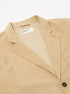 The Sand Organic Fine Cord Two Button Jacket is shown from the rear three-quarter angle as a flat lay against a plain white background. The image highlights the two-piece sleeve construction, the back seams, and the fine-wale texture of the sand-colored organic cotton corduroy.