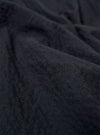 A close-up fabric swatch of the Dark Navy Ospina Cotton Two Button Jacket highlights the deep navy blue color and the distinct puckered texture of the seersucker fabric. The material fills the frame, providing a detailed view of the garment's weave and construction.