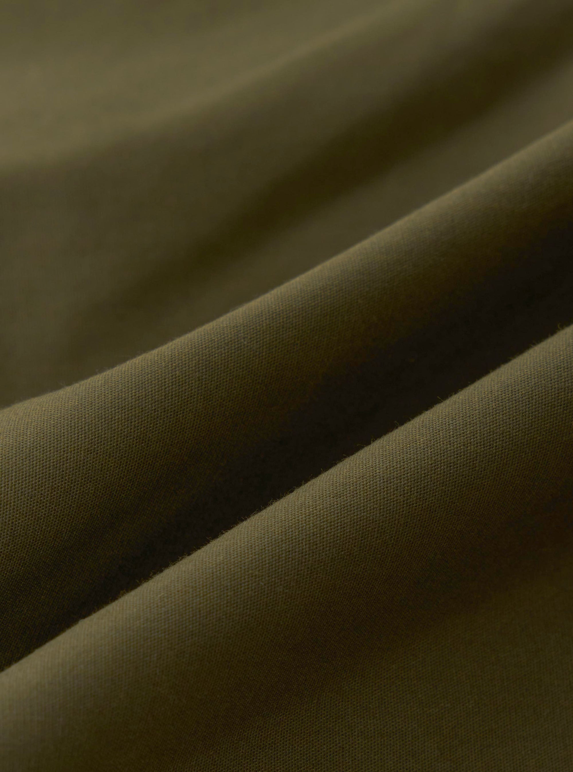 A close-up fabric swatch of the Olive Recycled Polytech City Waistcoat showing the olive green color and texture of the recycled polytech material.