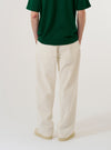 A model wears the Ecru Slub Drill Duke Pant against a plain white background, shown from the waist down in a rear three-quarter view. The image highlights the wide-leg fit, the single rear patch pocket, and the natural, irregular texture of the unbleached ecru cotton fabric.