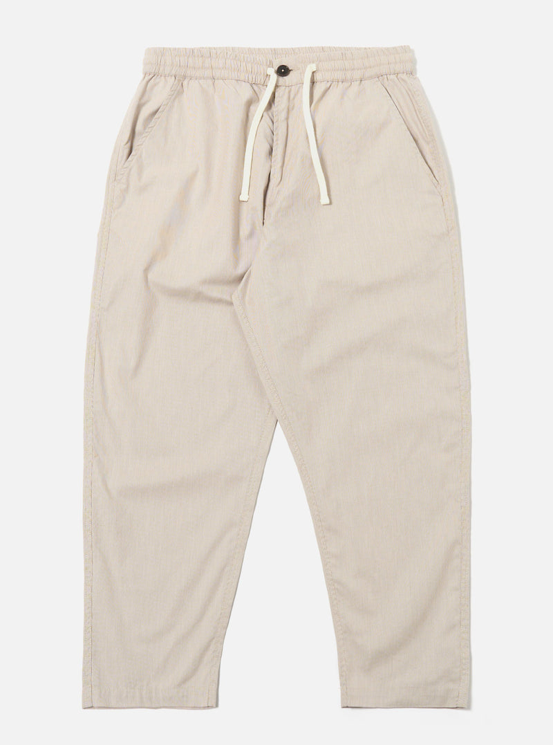 The Brown Kennedy Stripe Hi Water Trouser is shown as a flat lay against a white background. The trousers feature a vertical striped pattern in brown and tan tones. They are designed with an elasticated waistband, a visible drawstring, and a slim, cropped leg.