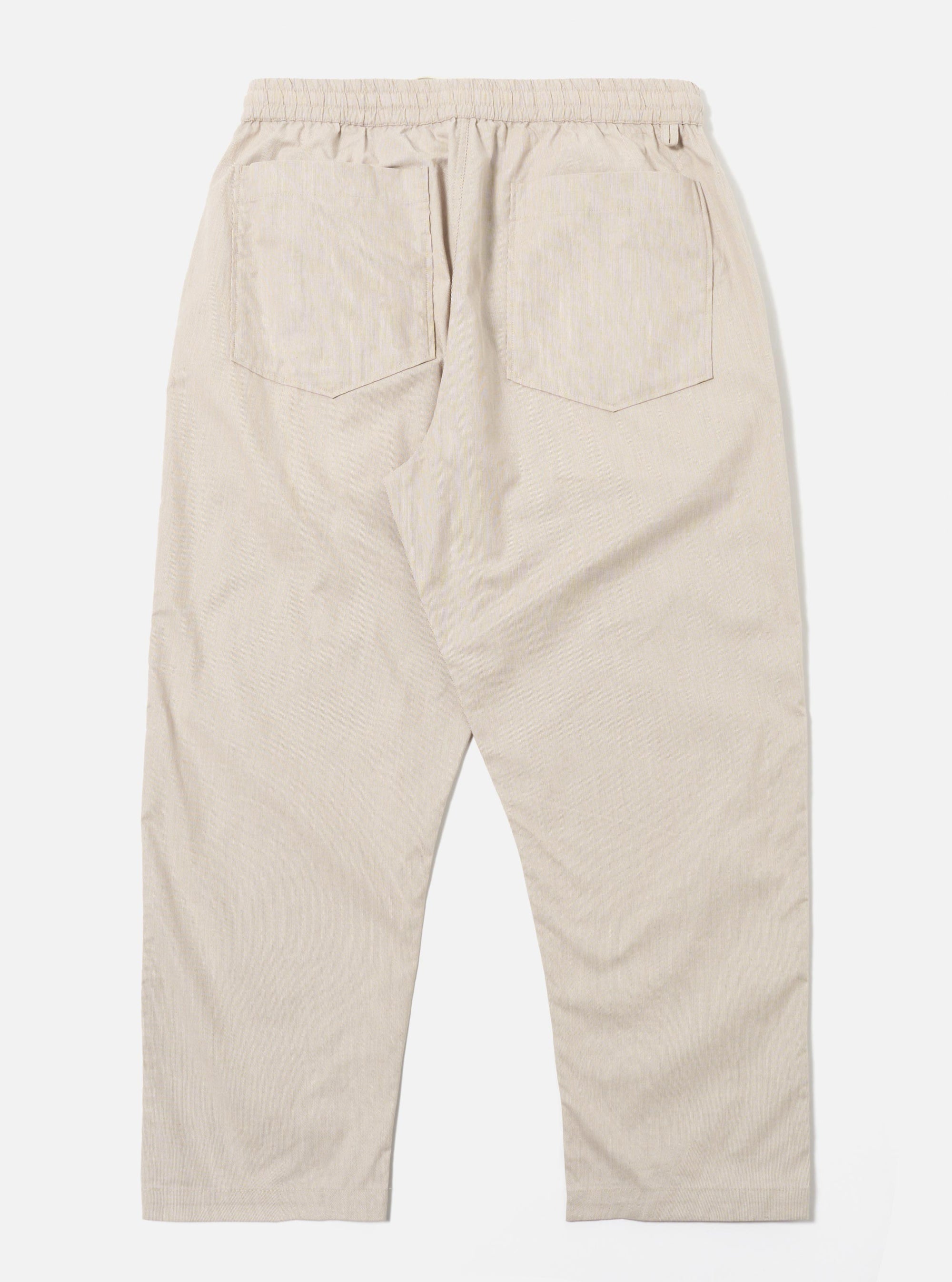 The Brown Kennedy Stripe Hi Water Trouser is shown from the rear as a flat lay against a plain white background. The trousers feature an all-over vertical brown stripe pattern, two rear patch pockets, and an elasticated waistband. The cropped, "Hi Water" length and slim fit are visible in the garment's construction.