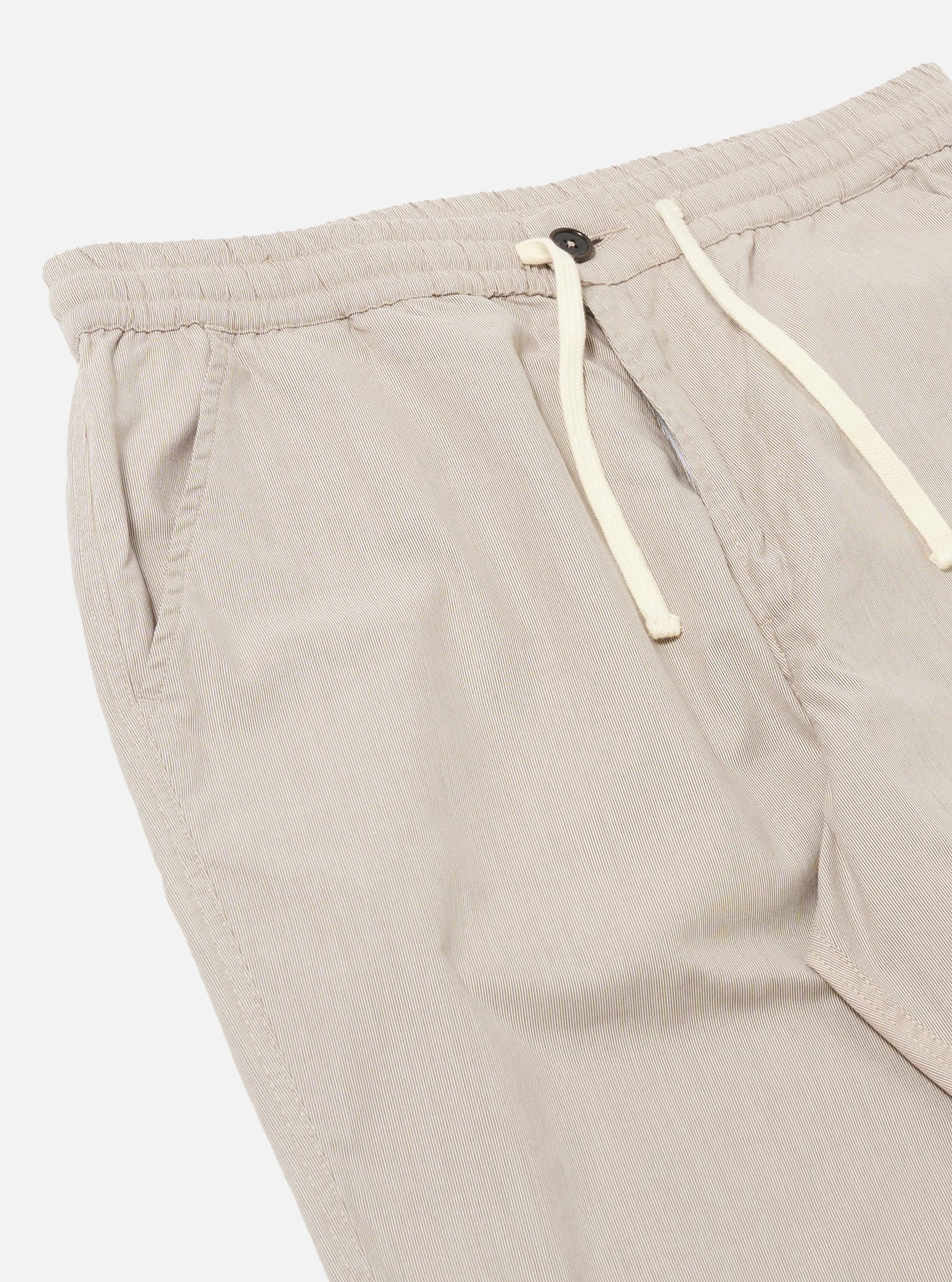 The Brown Kennedy Stripe Hi Water Trouser is shown from the back as a flat lay against a plain white background. The trousers feature a vertical brown stripe pattern and a cropped length. The image highlights the elasticated waistband with a drawstring closure and the slim construction of the rear.