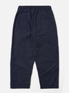 The Navy Peached Poplin Judo Pant is shown from the rear in a flat lay against a plain white background. The image highlights the back of the trousers, showing a single rear patch pocket on the right side and an elasticated waistband with internal drawstring detailing. The peached poplin fabric appears smooth and matte in a deep navy blue. No model or mannequin is present.