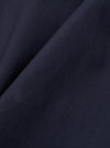 A close-up swatch image of the Navy Peached Poplin Judo Pant fabric displays a deep navy blue color with a smooth, matte finish. The fine, dense weave of the cotton poplin material is clearly visible, highlighting the peached texture.