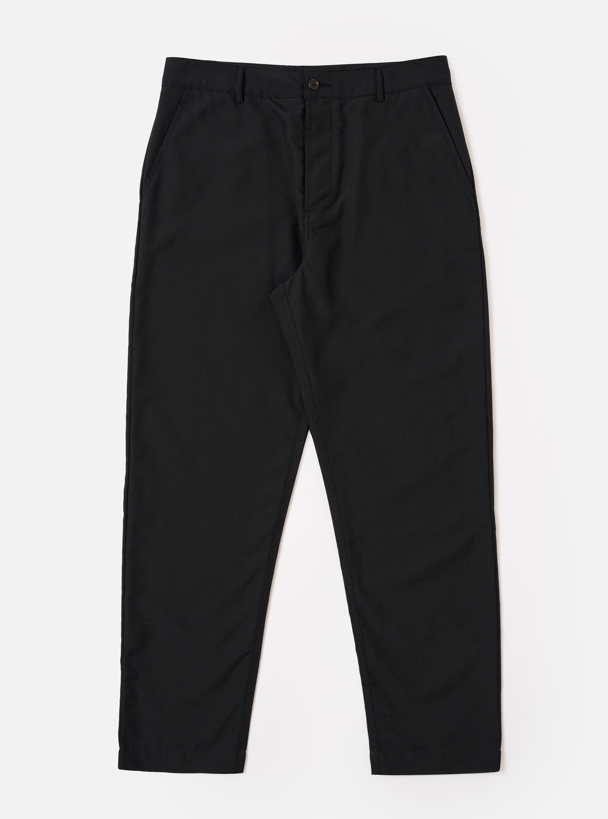 The Black Tropical Suiting Military Chino is shown as a flat lay against a white background. The trousers feature a slim, straight-leg fit, a mid-rise waist with a button fly, and two slanted front pockets. The fabric is a smooth, black tropical suiting material.