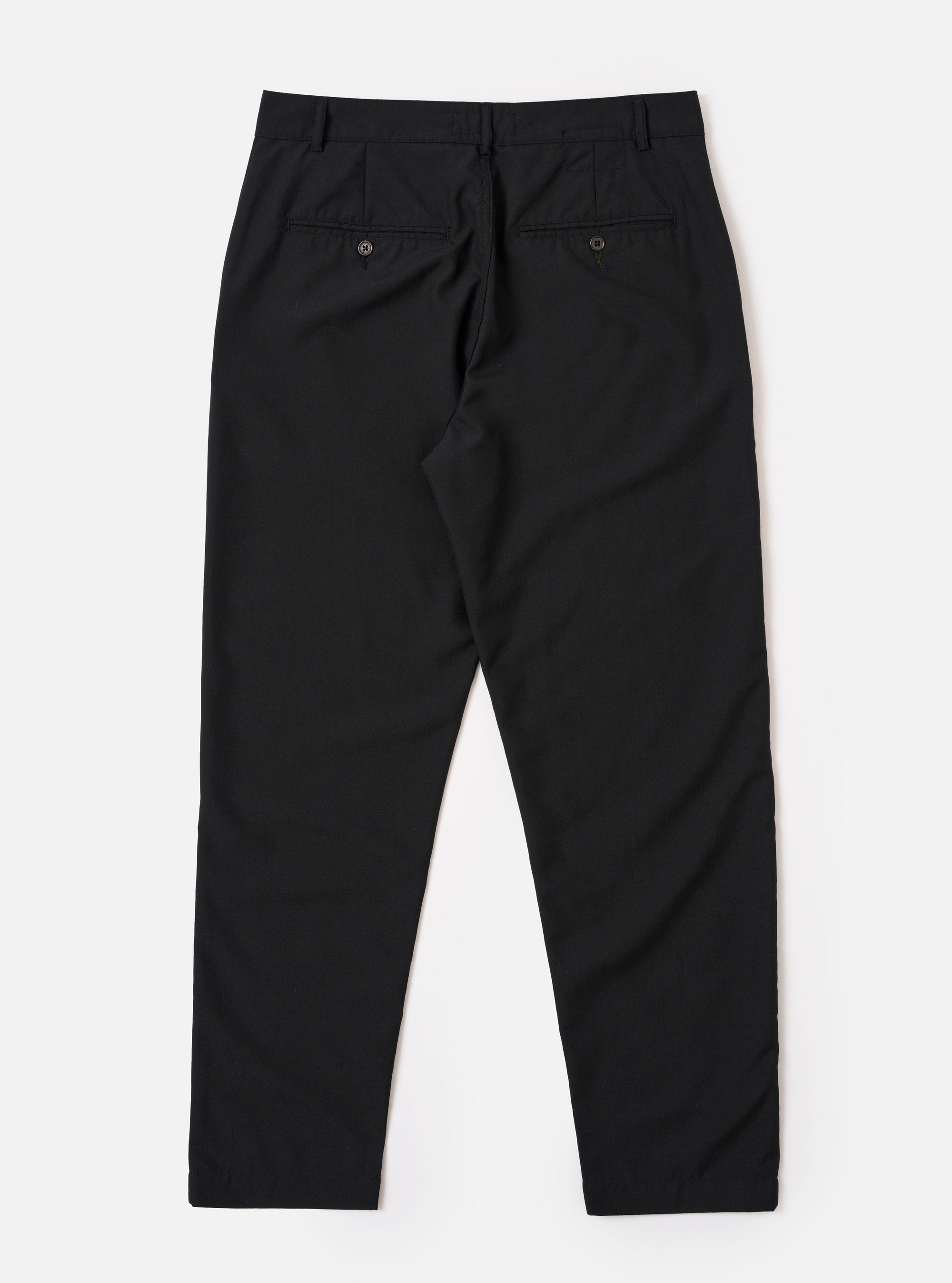 The Black Tropical Suiting Military Chino is shown from a rear angle as a flat lay against a plain white background. The image highlights the two rear jetted pockets with button closures and the clean, straight-leg construction of the trousers.