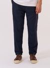 A model wears the Navy Recycled Polytech Military Chino, shown from the waist down against a plain white background. The image highlights the contemporary slim-straight fit of the trousers, which feature a mid-rise, a button fly, and two front pockets. The dark navy fabric is a smooth recycled polyester and cotton blend. The model is wearing the chinos with a light-colored shirt and dark footwear.