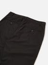 The Black Recycled Polytech Military Chino is shown from a rear angle as a flat lay against a plain white background. The image highlights the two rear jetted pockets with button closures and the clean, straight-leg construction of the black technical fabric.