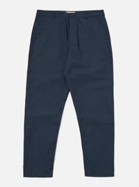 The Navy Recycled Polytech Military Chino is shown as a flat lay against a plain white background. The trousers feature a button closure at the waist, a central zip fly, and two slanted front pockets. The dark navy fabric has a smooth, technical finish, and the garment is cut with a slight taper toward the hem.