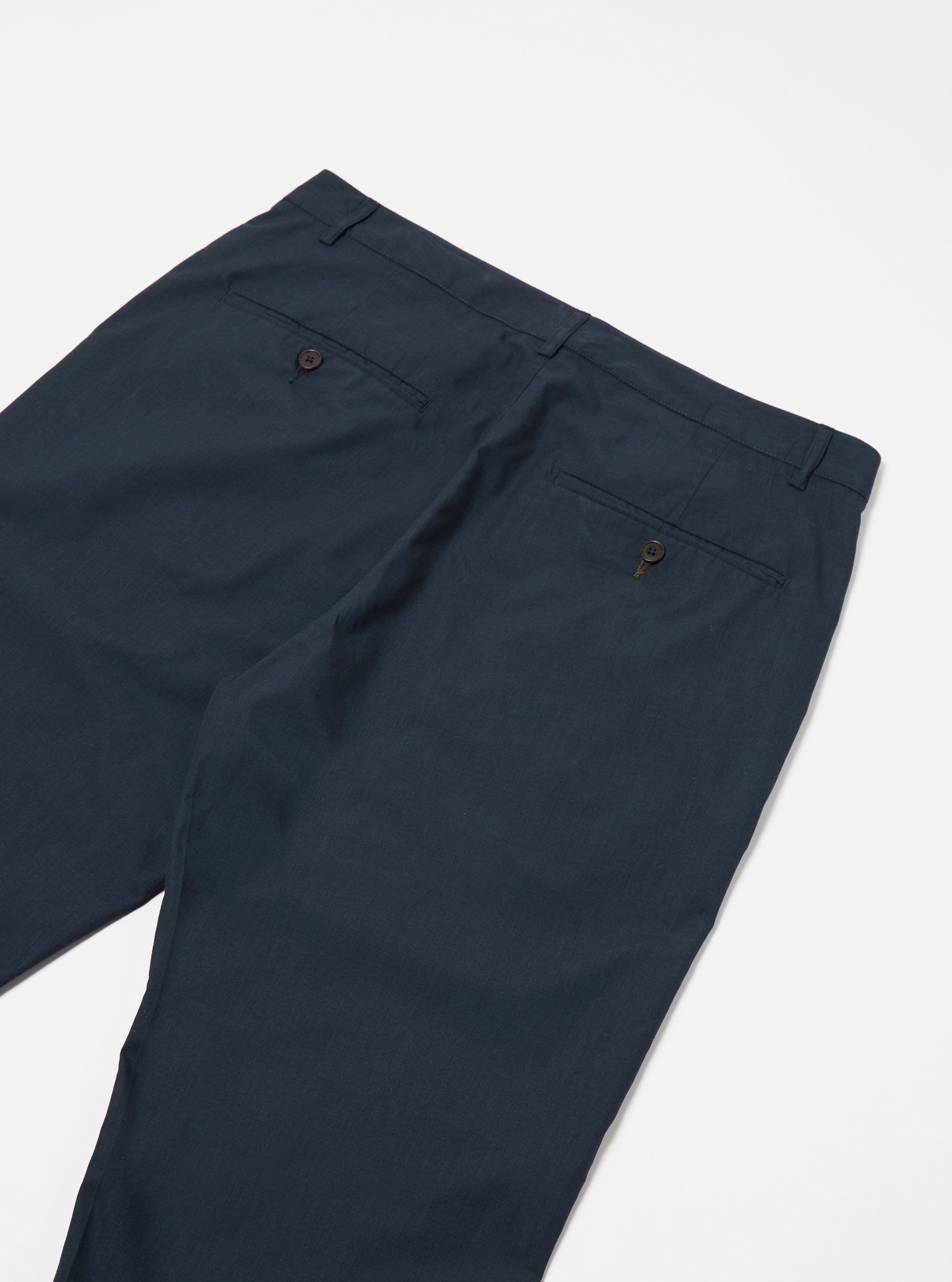 The Navy Recycled Polytech Military Chino is shown from a rear angle as a flat lay against a plain white background. The image highlights the two rear pockets, including one with a button-down flap, and the clean construction of the waistband.