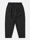 The Black Tropical Suiting Pleated Track Pant is shown as a flat lay against a plain white background. The trousers feature an elasticated waistband with an internal drawstring, a single front pleat on each leg, and two side pockets. The black tropical suiting fabric is a lightweight polyester and wool blend with a smooth finish.