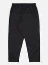 The Black Recycled Polytech Pleated Track Pant is shown from the rear as a flat lay against a plain white background. The image highlights the elasticated waistband and two rear pockets, including one with a buttoned flap on the left and a buttoned jetted pocket on the right. The black fabric has a smooth, technical appearance.