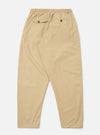 The Sand Recycled Polytech Pleated Track Pant is shown from the back as a flat lay against a plain white background. The image highlights the elasticated waistband and the two rear pockets, including one with a buttoned flap and one jetted pocket with a button closure. The fabric is a smooth, sand-colored recycled polyester and cotton blend.