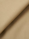 A close-up fabric swatch of the Sand Recycled Polytech Pleated Track Pant is shown, highlighting the light sand color and the smooth, technical weave of the recycled polyester and cotton blend.