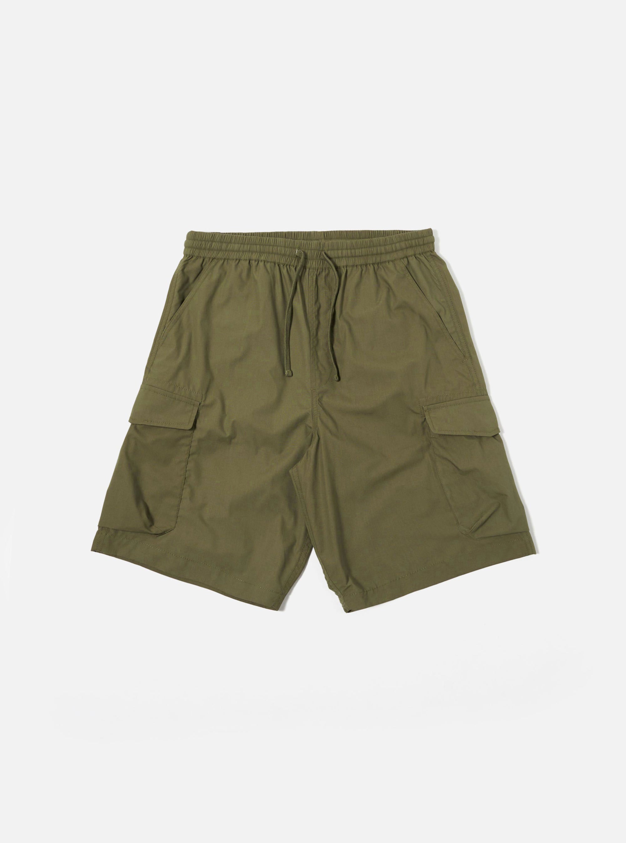 The Olive Recycled Polytech Parachute Short is shown as a flat lay against a plain white background. The shorts feature a relaxed fit, an elasticated waistband with a tonal drawstring, and two large 3D bellows cargo pockets on the sides. The garment is made from a smooth olive green fabric with visible stitching details.