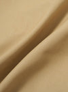 A close-up fabric swatch of the Sand Recycled Polytech Parachute Short is shown, highlighting the fine, technical weave and light beige color of the material.