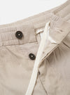 The Brown Kennedy Stripe Pleated Track Short is shown from the back as a flat lay against a white background. The image highlights the single rear button-down flap pocket and the vertical brown and white stripe pattern.
