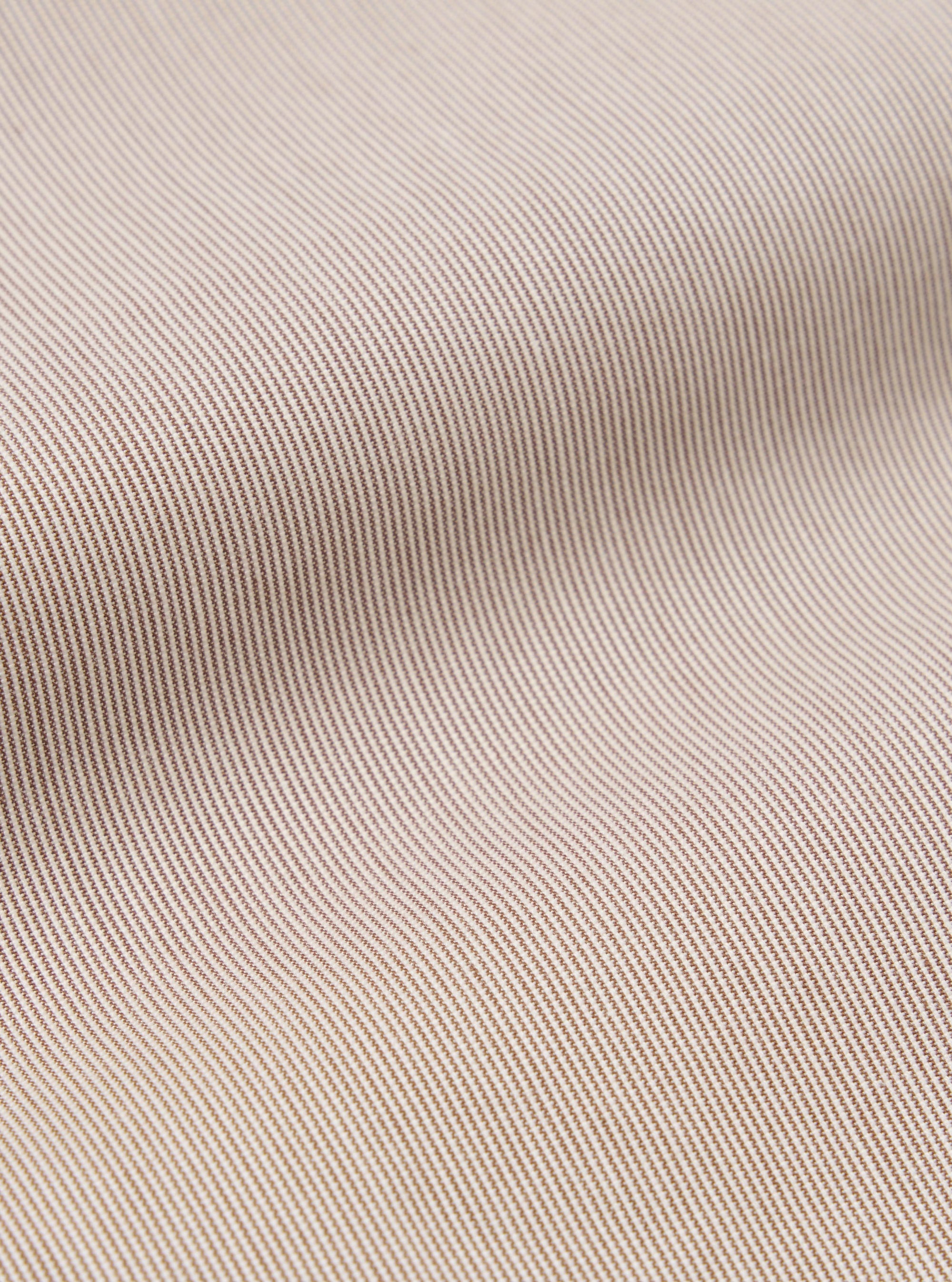 A close-up swatch image of the Brown Kennedy Stripe Pleated Track Short fabric displays a brown base with a prominent vertical stripe pattern. The texture of the cotton material is clearly visible, and the fabric fills the entire frame.