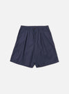 The Navy Peached Poplin Pleated Track Short is shown as a flat lay against a white background. The shorts feature a single pleat on the front, an elasticated waistband with a button closure, and two side hand pockets. The navy cotton fabric has a smooth, peached finish.